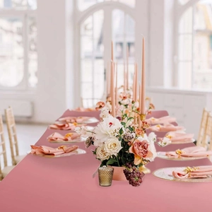 Close-up of elegant rose gold table runner draped over a long table for events
