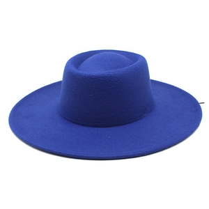 Detailed macro view of the structured crown and royal blue wool felt texture of the boater hat