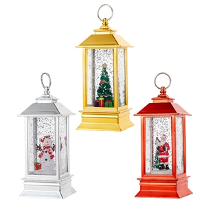 Three metallic Christmas lanterns with Santa, snowmen and glitter inside for festive decor