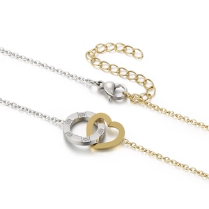 Two-tone stainless steel necklace with crystal-embedded ring and gold heart pendant
