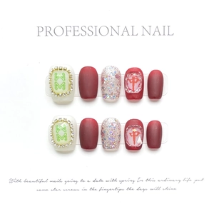 Chinese mahjong style press-on nails with red matte finish and rhinestone accents