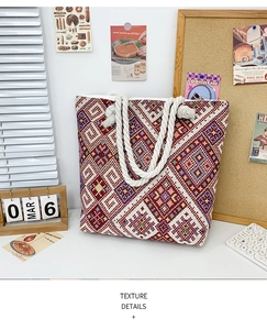 Detailed close-up of geometric ethnic woven tote bag with white cotton rope handles