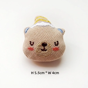 Close-up of a khaki knitted bear head DIY accessory with dimensions 5.5cm x 4cm