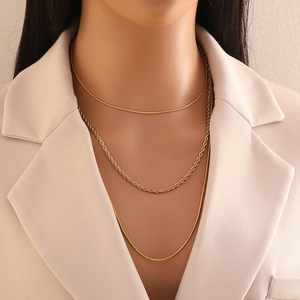 Chic triple-layered gold necklace for women featuring three distinct metallic chains