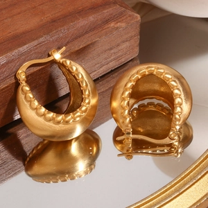 Detailed macro view of 18K gold-plated stainless steel C-shaped earrings with brushed texture