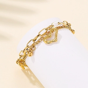 Bracelet double rang en acier inoxydable doré avec cœur texturé et breloque perle polie