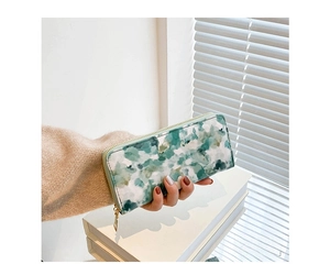 Detail of lady's long purse with watercolor marble pattern and gold zipper closure