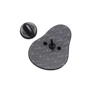 Macro shot of matte black metal avocado brooch back with geometric anti-slip texture