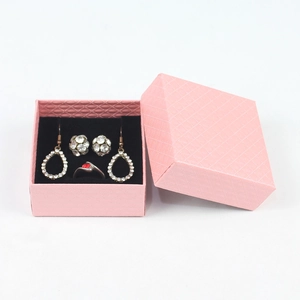 Pink jewelry gift box with textured pattern showing necklace, earrings and ruby ring