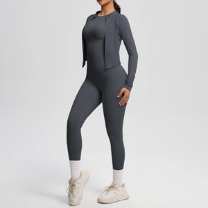 Three-piece dark gray yoga set including zip-up jacket, sports bra and seamless leggings