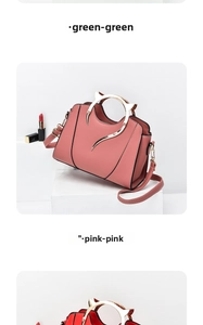 Detail of pink handbag with golden cat-ear metal handles and detachable strap on white stand