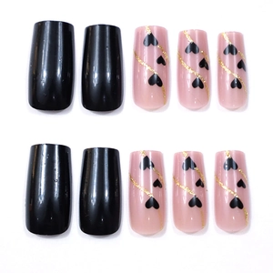 Detail of pink and black press-on nails with golden line heart designs and glossy finish