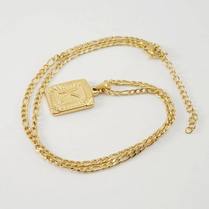 Detail view of 18K gold-plated square pendant with letter K on a Figaro chain necklace