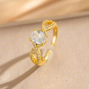 Elegant gold bow-shaped adjustable ring with large oval zircon and twisted pavé band