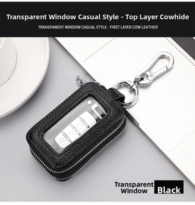 Black leather key pouch with double zippers and clear window on a desk setup