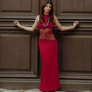 Detail of red sleeveless maxi dress showing transparent floral lace stitching on the waistline