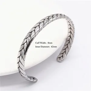 Detail of 8mm wide vintage titanium steel cuff with 62mm diameter and woven texture