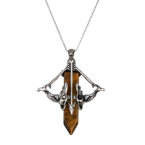 Macro detail of retro silver arrow pendant with natural tiger eye hexagonal stone