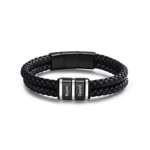 Detail of double-layer black woven leather bracelet with custom engraved metal beads