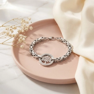 Détail d'un bracelet Arbre de Vie argenté avec cristaux sur un plateau rose élégant