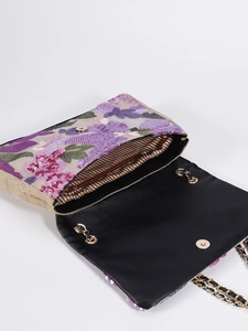 Detailed interior of sequin floral shoulder bag with striped lining and gold chain