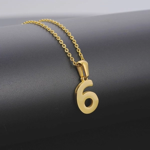 Close-up of number 6 pendant in 18K gold plated stainless steel with polished finish