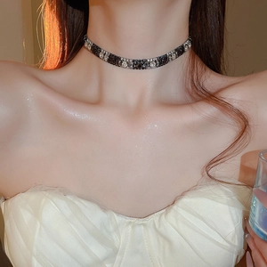 Close-up of elegant square black and round clear crystal choker on woman's neck