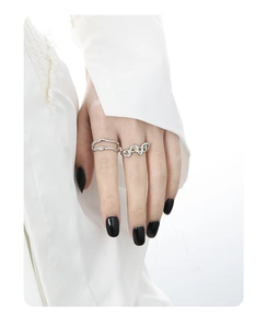 Detail view of silver hollow rings with yellow zircon inlay on model's fingers