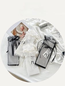 Close-up of sheer mesh socks in organza packaging with elegant decorative silk bows