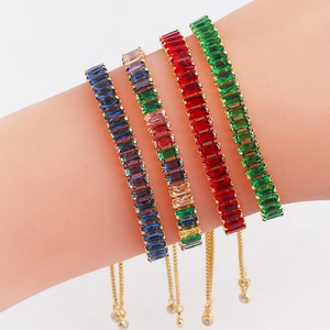Adjustable gold bracelets with colorful rectangular zircon crystals on a model wrist
