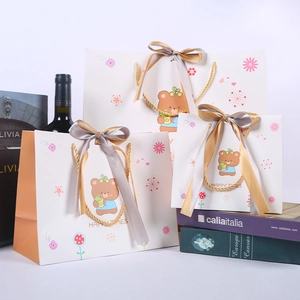 Cartoon bear gift bags in three sizes with golden handles and satin ribbon bows