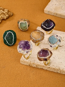 Close-up of bohemian adjustable rings with raw gemstones and sparkling crystal edges