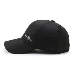 Men's black baseball cap with textured patchwork and sport shield logo in side view