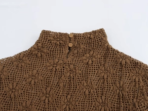 Detail view of brown crochet lace top showing mock neckline and back button closure