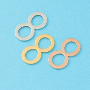 Three infinity symbol pendants in silver, gold, and rose gold on a blue background