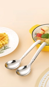 Detail of two 316L stainless steel thick spoons with polished finish in kitchen setting