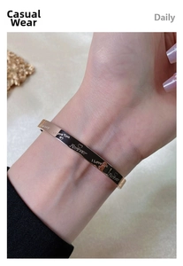 Detailed close-up of rose gold Love Forever bangle with heart engraving on wrist