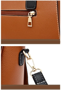 Close-up of brown litchi pattern leather with white stitching and gold metal hardware detail