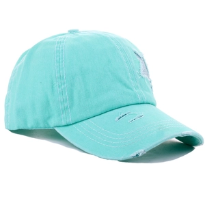 Detail of mint green baseball cap featuring distressed holes and silver sequin star patch