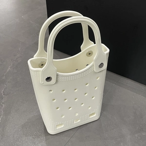 Macro detail of waterproof EVA beach tote featuring round ventilation holes and rivets