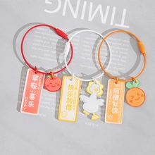 Close-up of red, yellow and orange candy-colored keychains with lucky charms