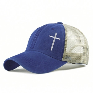 Detail of cross embroidery on blue cotton front and breathable beige mesh trucker hat