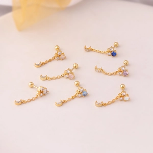 Gold moon and star chain stud earrings with multi-colored cubic zirconia in detail