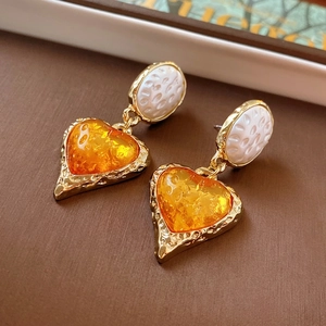 Vintage heart earrings with white textured studs and amber resin drops in gold frame