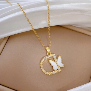 Luxurious D-shaped butterfly necklace with crystals and white shell on gold chain