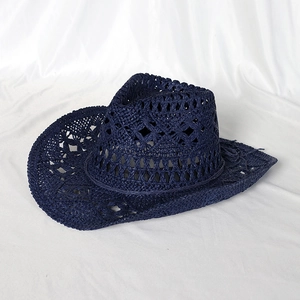 Detailed top view of navy blue hollow woven straw cowboy hat with decorative patterns