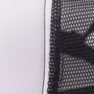 Close-up of trucker hat seams featuring white sponge fabric and black nylon mesh netting