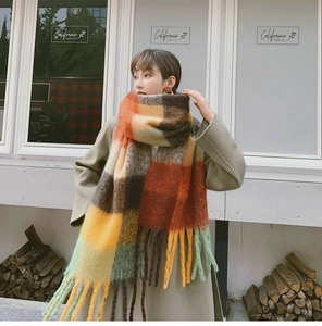 Detail of colorful plaid mohair scarf with tassels and thick brushed wool texture