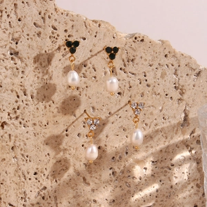 Detail of 18K gold plated hoop earrings with three crystals and freshwater pearl drops