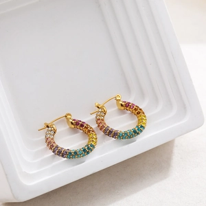 Close-up of 18K gold hoop earrings with multi-color rainbow crystals and polished finish